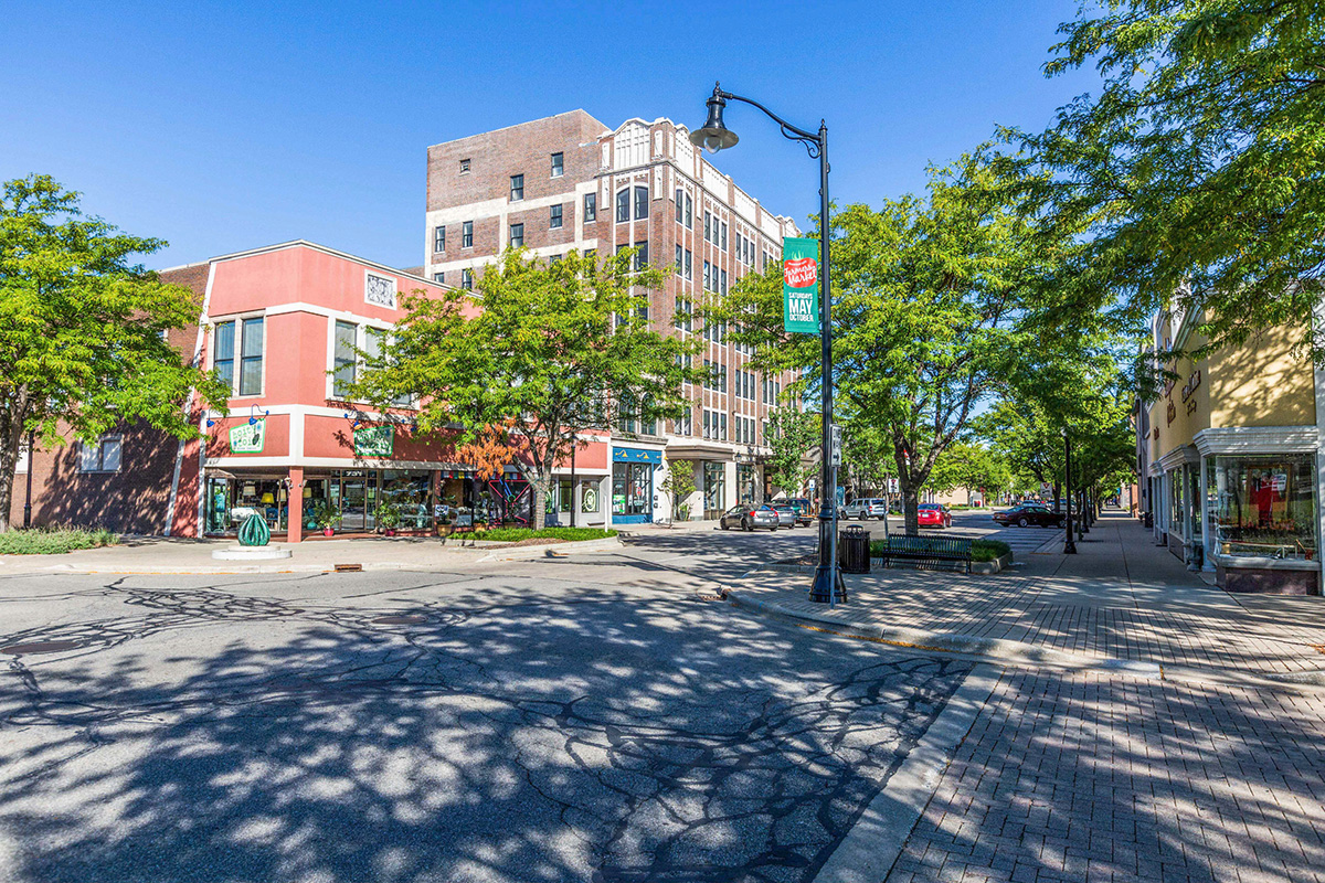 View of downtown Michigan City, Indiana with historic buildings, tree-lined streets, and storefronts.